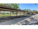 Assigned covered parking area with ample space for vehicles and green surroundings at 5078 Marsh Field Rd # 82, Sarasota, FL 34235