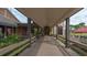 Covered outdoor walkway with beams and railings leading to a clubhouse entrance at 5078 Marsh Field Rd # 82, Sarasota, FL 34235