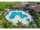 Aerial view showcasing a community pool with palm trees, lounge chairs and seating areas at 510 16Th E Ave, Palmetto, FL 34221