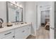 Bright bathroom featuring a white vanity, quartz countertops, framed mirrors, and views into the bedroom at 510 16Th E Ave, Palmetto, FL 34221