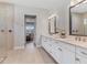 Well-lit bathroom features double vanity, quartz counters, framed mirrors, and a large glass shower at 510 16Th E Ave, Palmetto, FL 34221