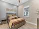 Cozy bedroom with natural light features brick accent wall, modern ceiling fan, and wood-look tile flooring at 510 16Th E Ave, Palmetto, FL 34221