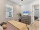 Cozy bedroom with natural light features brick accent wall, modern ceiling fan, and wood-look tile flooring at 510 16Th E Ave, Palmetto, FL 34221