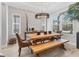 Bright dining room featuring exposed brick, decorative pendant lighting, and a wooden table with a bench at 510 16Th E Ave, Palmetto, FL 34221
