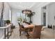 Bright dining room boasts light wood flooring, exposed brick accent wall, and modern lighting fixture at 510 16Th E Ave, Palmetto, FL 34221