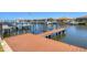Dock featuring a boat lift on a sunny day, providing direct access to the water for boating and waterfront activities at 510 16Th E Ave, Palmetto, FL 34221