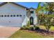 Beautifully landscaped home featuring a two-car garage, brick driveway, and inviting entryway at 510 16Th E Ave, Palmetto, FL 34221