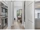 Hallway view showing stainless steel oven and dining room in the distance at 510 16Th E Ave, Palmetto, FL 34221