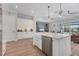 Kitchen with large island, white cabinetry, stainless steel appliances, and pendant lighting at 510 16Th E Ave, Palmetto, FL 34221