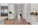 Modern kitchen seamlessly transitions into the dining room, boasting stainless steel appliances and wood floors at 510 16Th E Ave, Palmetto, FL 34221