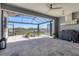 Large screened lanai with waterfront views, featuring an outdoor cooking area and comfortable seating at 510 16Th E Ave, Palmetto, FL 34221