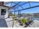Inviting covered lanai with comfortable seating around a fire pit overlooking the water, perfect for entertaining at 510 16Th E Ave, Palmetto, FL 34221