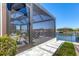 Screened lanai featuring pavers, waterfront views, and outdoor seating; a perfect space to relax and enjoy coastal living at 510 16Th E Ave, Palmetto, FL 34221