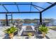 Relaxing covered lanai featuring waterfront views, comfortable lounge chairs and a modern fire pit centerpiece at 510 16Th E Ave, Palmetto, FL 34221