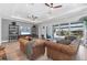 Open-concept living room with tray ceilings, recessed lighting, hardwood floors, and sliding glass doors to the outside at 510 16Th E Ave, Palmetto, FL 34221