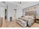 Relaxing main bedroom featuring tray ceilings, wood-look tile flooring, and brick accent wall at 510 16Th E Ave, Palmetto, FL 34221