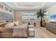 Comfortable main bedroom featuring tray ceilings, wood-look tile flooring, and brick accent wall at 510 16Th E Ave, Palmetto, FL 34221