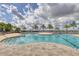 Inviting pool with clear blue water and a spacious patio area with lounge chairs and lush palm trees at 510 16Th E Ave, Palmetto, FL 34221