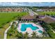 Stunning aerial view of a resort-style pool area with a clubhouse and lush landscaping at 510 16Th E Ave, Palmetto, FL 34221