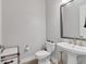 Neutral powder room with pedestal sink, modern fixtures, and decorative accents, offering a minimalist design at 510 16Th E Ave, Palmetto, FL 34221