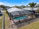 Aerial view of home with screened-in pool surrounded by decorative rock at 5319 Levi Ln, Sarasota, FL 34233