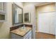 Bright bathroom featuring glass bowl sink, tiled floors, and framed mirror at 5319 Levi Ln, Sarasota, FL 34233