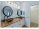 Bathroom featuring bowl sinks, granite countertops, and lots of mirrors at 5319 Levi Ln, Sarasota, FL 34233