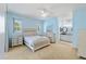 Airy bedroom with light blue walls, neutral carpet, and an en-suite bathroom at 5319 Levi Ln, Sarasota, FL 34233