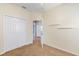 Bedroom with neutral walls, plush carpet, and double closet with white doors at 5319 Levi Ln, Sarasota, FL 34233