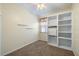 Bedroom with beige walls, plush carpet, and built-in closet shelving at 5319 Levi Ln, Sarasota, FL 34233
