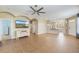 Open-concept living room boasts tile floors, a ceiling fan, and seamless flow to the kitchen area at 5319 Levi Ln, Sarasota, FL 34233