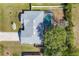 Aerial view of a home showcasing its roof, driveway, and screened pool in a well-maintained backyard at 5330 Alseir Rd, North Port, FL 34288