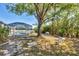 Outdoor space with a screened pool, mature trees, and charming decorative touches, creating a tranquil retreat at 5330 Alseir Rd, North Port, FL 34288