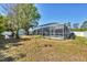 Spacious backyard with a screened pool area, offering ample space for outdoor entertainment and relaxation at 5330 Alseir Rd, North Port, FL 34288