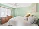 Cozy bedroom featuring a ceiling fan, natural light, and a neutral color scheme for a relaxing atmosphere at 5330 Alseir Rd, North Port, FL 34288