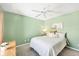 Cozy bedroom with green walls, carpet, a ceiling fan, and neutral decor at 5330 Alseir Rd, North Port, FL 34288