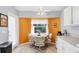 Eat-in kitchen area with orange accent wall, white cabinets, and natural light at 5330 Alseir Rd, North Port, FL 34288