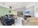 Bright living room features stylish furniture, ceiling fan, and sliding glass doors at 5330 Alseir Rd, North Port, FL 34288