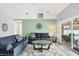 Cozy living room with modern decor, ceiling fan, and sliding doors to the lanai at 5330 Alseir Rd, North Port, FL 34288