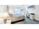 Inviting bedroom with a calm ambiance, featuring natural light and a desk space at 5330 Alseir Rd, North Port, FL 34288