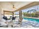 Tranquil screened-in pool area with outdoor seating, blue water, and a peaceful ambiance for relaxation at 5330 Alseir Rd, North Port, FL 34288
