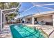 Beautiful screened-in pool with pristine blue water, perfect for relaxation and outdoor enjoyment at 5330 Alseir Rd, North Port, FL 34288