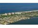 Breathtaking aerial view of waterfront properties nestled along the coast with stunning beach access and serene waters at 537 Gunwale Ln, Longboat Key, FL 34228