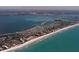 Spectacular aerial view of a coastal community with direct beach access, showcasing stunning waterfront properties at 537 Gunwale Ln, Longboat Key, FL 34228