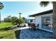Beautiful backyard featuring a paved patio, table and chairs for outdoor dining, and lush landscaping at 537 Gunwale Ln, Longboat Key, FL 34228