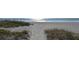 Sandy path through natural dunes, leading to a pristine beach and inviting ocean views at 537 Gunwale Ln, Longboat Key, FL 34228
