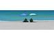 Two beach chairs under a pair of umbrellas on a sandy beach with turquoise waters at 537 Gunwale Ln, Longboat Key, FL 34228