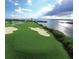 Scenic golf course with lush green fairways, sand bunkers, and stunning water views for a premium recreational experience at 537 Gunwale Ln, Longboat Key, FL 34228