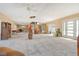 Spacious living room with a ceiling fan, neutral paint, and natural light at 537 Gunwale Ln, Longboat Key, FL 34228