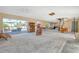 Spacious living room featuring an open layout, sliding glass doors to the outdoor patio, with water damage to the walls at 537 Gunwale Ln, Longboat Key, FL 34228